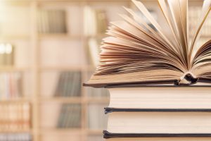 Old stacked books on background